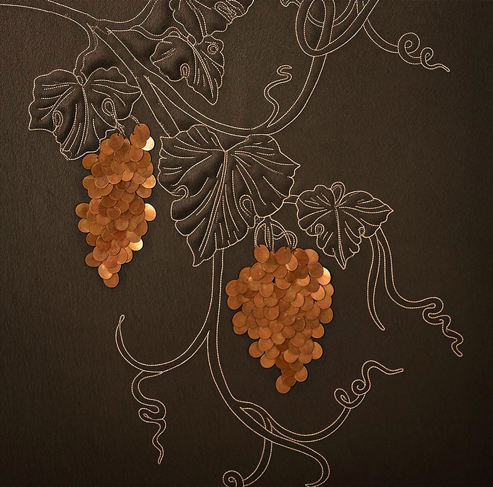 Bronze grape artwork embroidered on dark leather